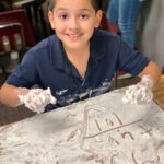 AMS-Camelback-student with math in sand