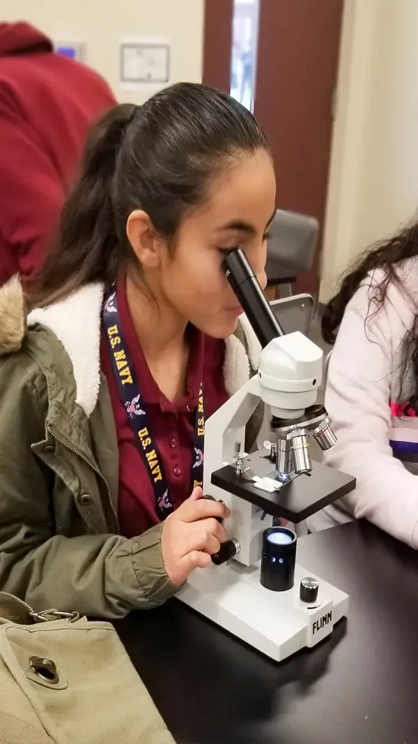 AMS student with microscope