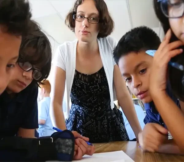 AMS teacher with students in classroom